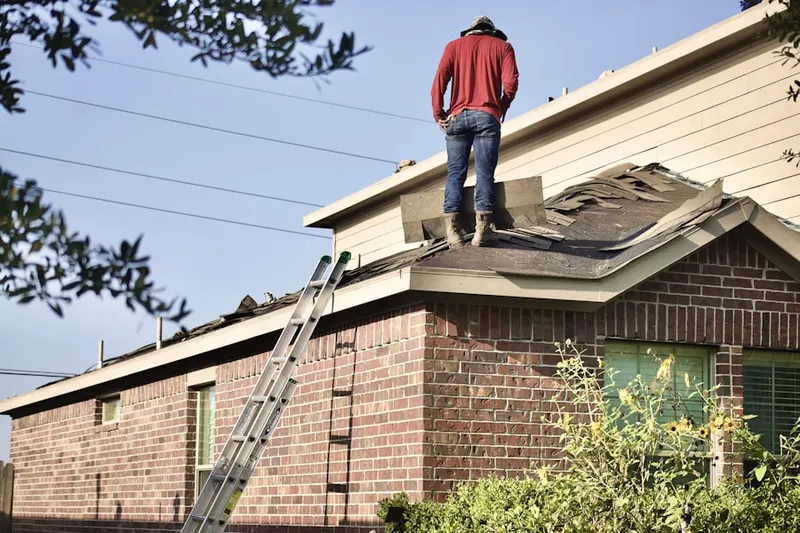 Professional roofer working on a residential roof in Battery Marina Village